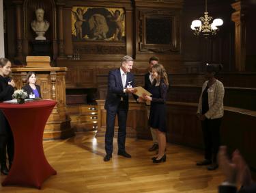 Germany Scholarship recipient receiving the certificate from her sponsor
